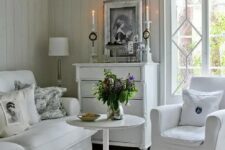 a neutral vintage living room with elegant and chic furniture, a white sideboard, candles and potted plants is very stylish