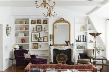 a refined vintage living room with a printed sofa, a purple lounger, leopard chairs, a fireplace, built-in shelves and a mirror in a gilded frame