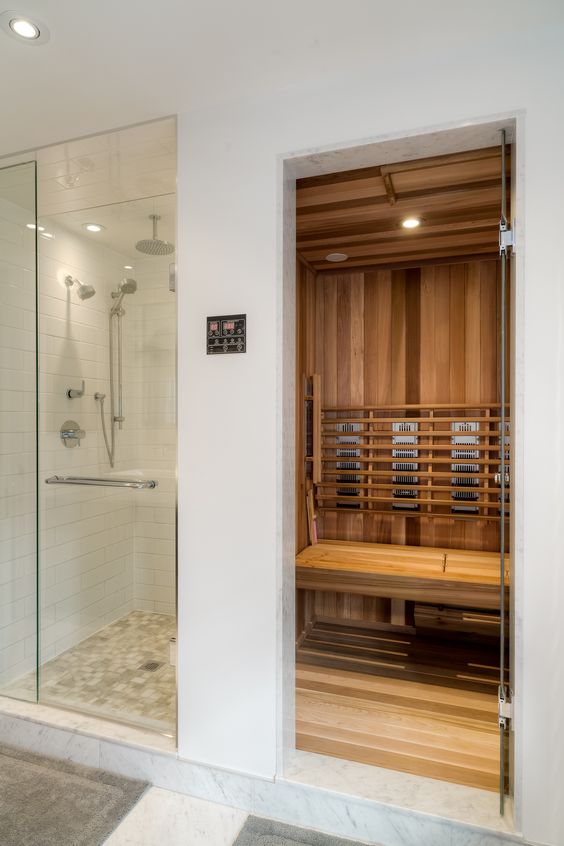 a small home steam room done with wood, with built-in lights is cool and cozy