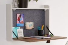a small storage space with a foldable desk surface, some plants and felt inside the box is a cool idea