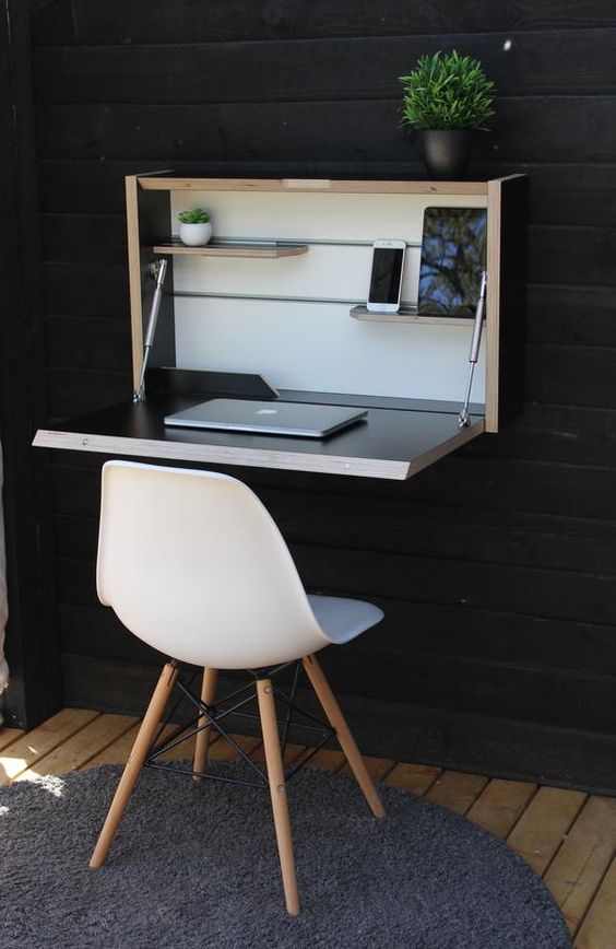 A stylish wall mounted foldable desk in neutrals and dark colors is a very stylish idea suitable for small spaces