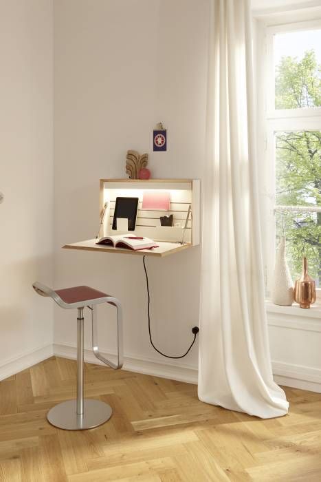 a wall-mounted foldable mini desk with built-in lights and with books and other necessary stuff