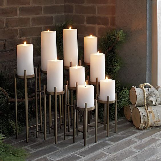 an architectural candelabra for nine pillar candles on graduated risers on long lean legs