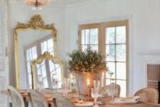 a beautiful antique French chic dining room with a vintage dining table, vintage chairs, crystal chandeliers, mirrors in gilded frames and crystal chandeliers