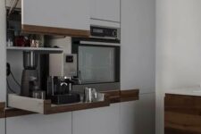a cabinet with a lifting up door and retractable shelves holding various kitchen appliances is a great idea