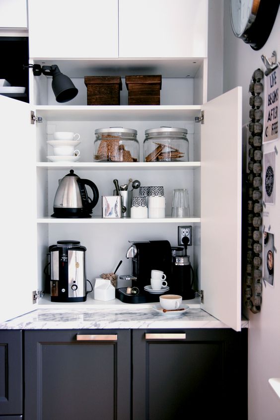 a cabinet with appliances, jars and mugs hidden inside and various stuff turn it into a pretty coffee station is a cool idea