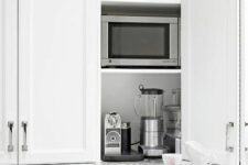 a cabinet with folding doors and some appliances and other stuff inside is a cool and smart idea for any kitchen