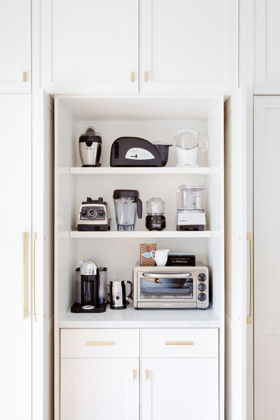 a cabinet with shelves holding various appliances is a cool and stylish idea to store them without cluttering the space