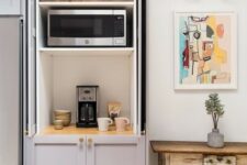 a cabinet with shelves that hides several appliances and creates a mini tea and coffee station you may use