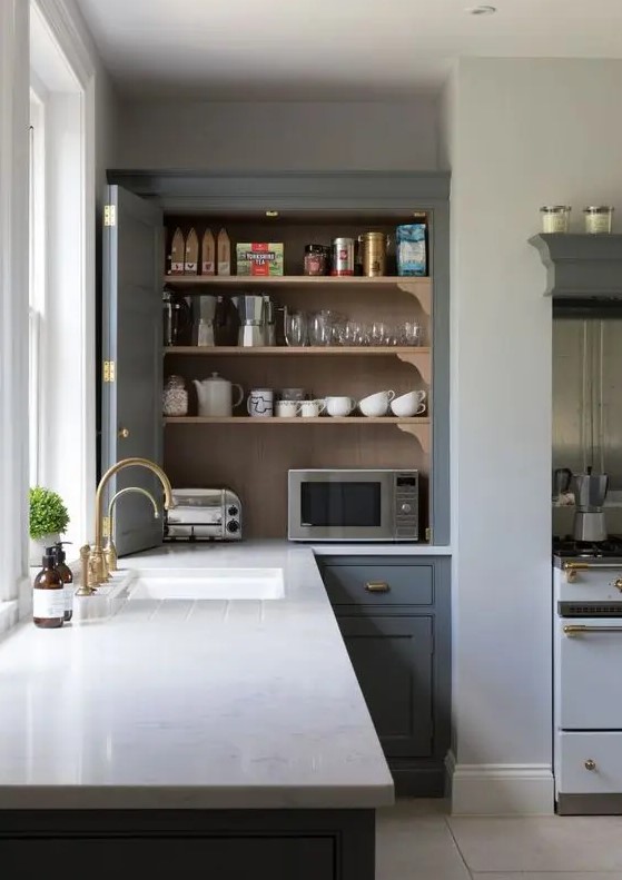 A kitchen cabinet with bi fold doors hiding several appliances and various other stuff is a cool idea