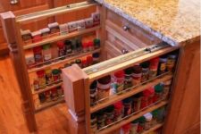 a kitchen island with vertical narrow drawers that are used for storing spices is a cool and smart solution for a modern or rustic space