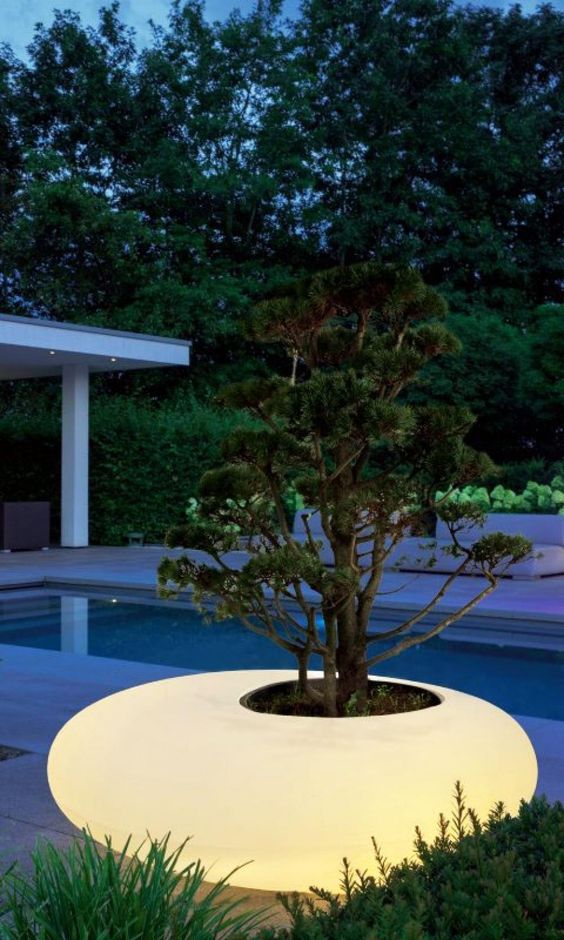 a large pebble outdoor planter is a creative solution for a modern outdoor space, it will add light and interest to the space