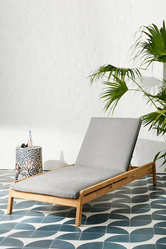 a modern neutral wood lounger with grey upholstery is a stylish and cool idea for a modern outdoor space