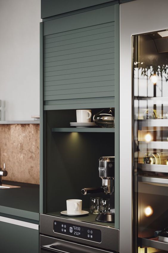 A small built in cabinet with a garage door and lights, with a coffee matching and some mugs is a home bar hidden