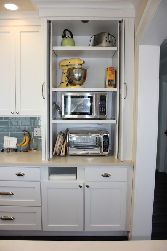 a small cabinet for storing various appliances is a cool idea for a storing things and for decluttering the kitchen
