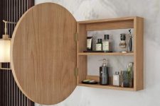 a small storage cabinet with a round mirror is a lovely idea for a modern bathroom, it can storage some items you don’t wanna see every time
