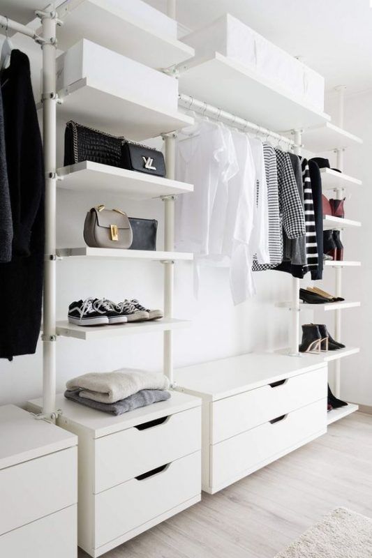 a stylish and simple white closet with open shelves, dressers and boxes overhead for storage is a cool minimalist idea