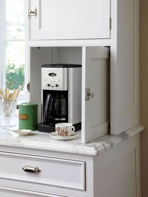 a tiny cabinet with a coffee machine, mugs and sugar is a real mini coffee station that will fit any kitchen