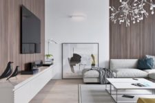 an elegant minimalist living room with wood panels, a floating TV unit, laconic neutrla furniture and artworks