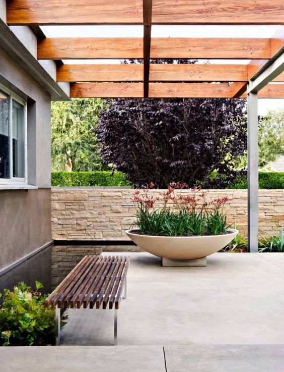 an oversized white concrete bowl planter is a stunning modern planter piece you can rock in your outdoor space