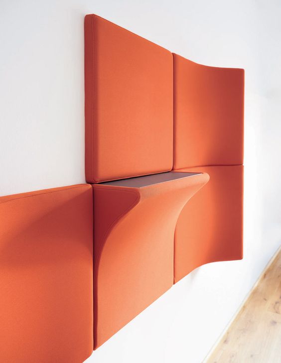 bold orange acousitc panels and a panel with an additional shelf is a very functional idea