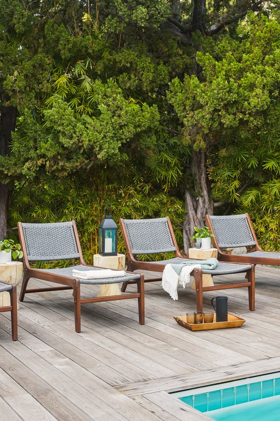 chic modern loungers of stained wood and grey wicker are amazing for a modern outdoor space, add blankets and pillows