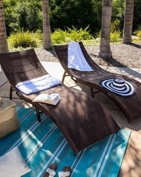 gorgeous dark curved wicker loungers with blankets and pillows are perfect for tropical, rustic and modern spaces