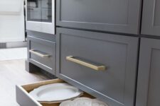 graphite grey cabinets featuring usual and low drawers is a cool idea for a modern space, put some dishes or lids into lower drawers