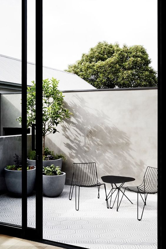 grey concrete cup-like planters are very chic and very modern, they will fit many outdoor spaces