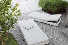 minimalist white loungers with a sleek design and backs that can be raised up for more comfort