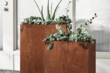 modern tall rusted metal planters will give a cool texture and color to the space and if you plant greenery, they will stand out