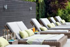 wicker loungers with white upholstery and colroful pillows are a classic and cool solutions for outdoors