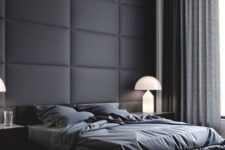 a black padded fabric statement wall perfectly fits a moody contemporayr bedroom with a masculine feel