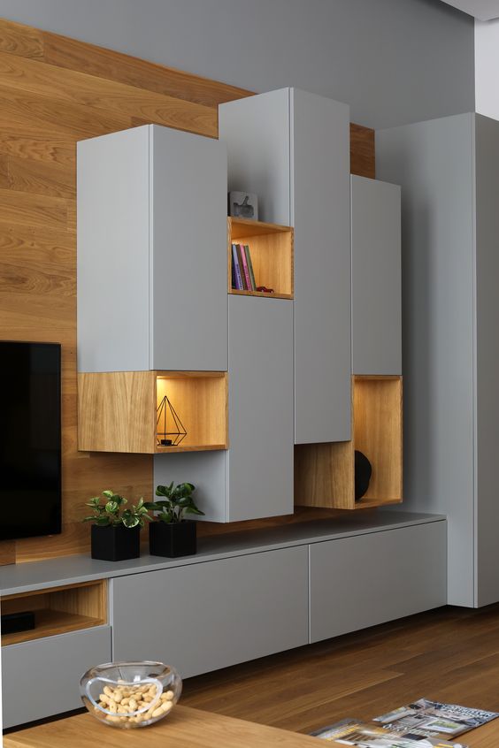 A gorgeous sleek grey and light stained wood wall storage unit with closed and open storage compartments is a very cool idea