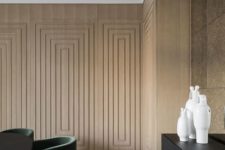 a plywood accent wall done with a series of frames adds elegance and a refined touch to the space