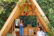a secret garden shed shaped as a teepee, with a reading and painting nook is amazing