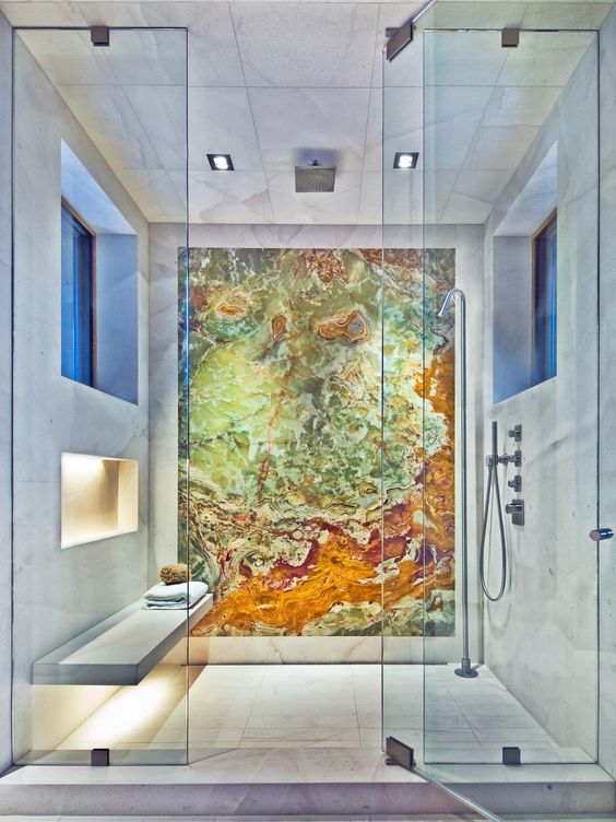 a spa-like shower space accented with a colorful geode statement wall that makes the shower even more gorgeous
