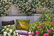a super bold spring terrace with greenery and blooms, with colorful textiles, potted plants and colorful pillows
