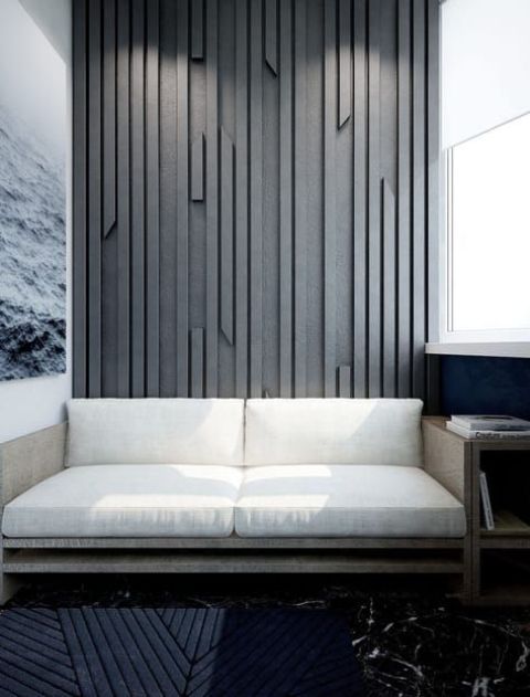 a textural accent wall done with wooden slabs attach to a plywood sheet and painted in an elegant grey shade