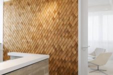 a unique textural accent wall clad with wooden shingles is a stylish contemporayr meets rustic idea