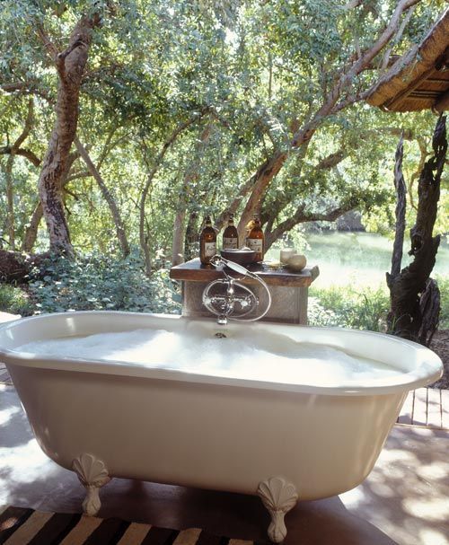 a vintage clawfoot bathtub with only the most necessary things is all you need to relax