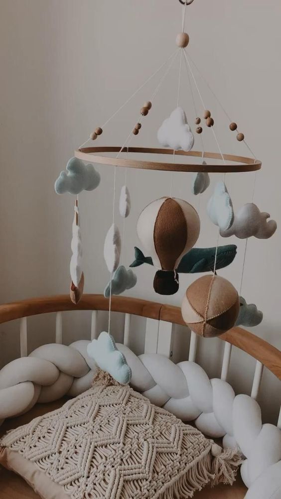 a cute baby mobile with clouds, wooden beads and hot air balloons is a lovely idea for many boys nurseries including a boho one