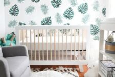 a leaf print wall, faux fur, a white leather ottoman and lots of natural light for a clean look in a tiny nursery