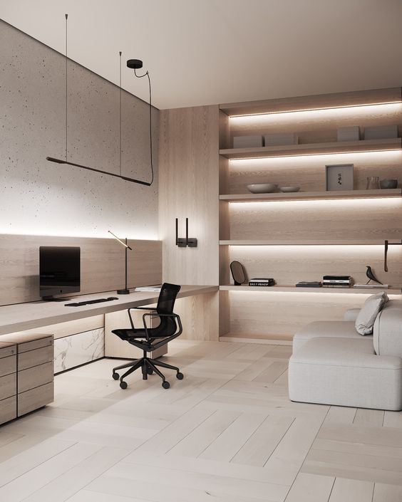 A luxurious minimalist home office with a sleek built in desk with storage, a black chair, a neutral sofa and built in shelves with lights is a cool space