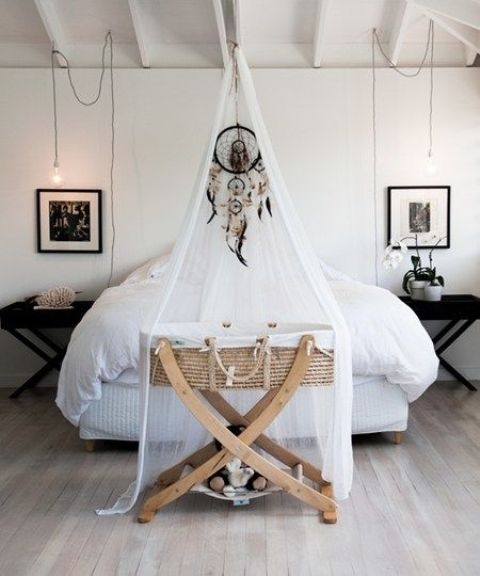a mosquito net with a dreamcatcher accenting the baby crib is a cute idea to highlight this piece