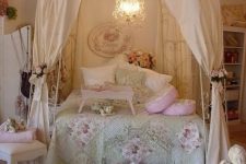a shabby chic kids’ room with a metal canopy bed, faux blooms everywhere, floral bedding and pretty vintage furniture