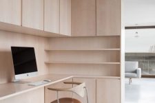 a stylish minimalist home office with light stained plywood, with storage units and open shelves, a cool plywood and leather chair