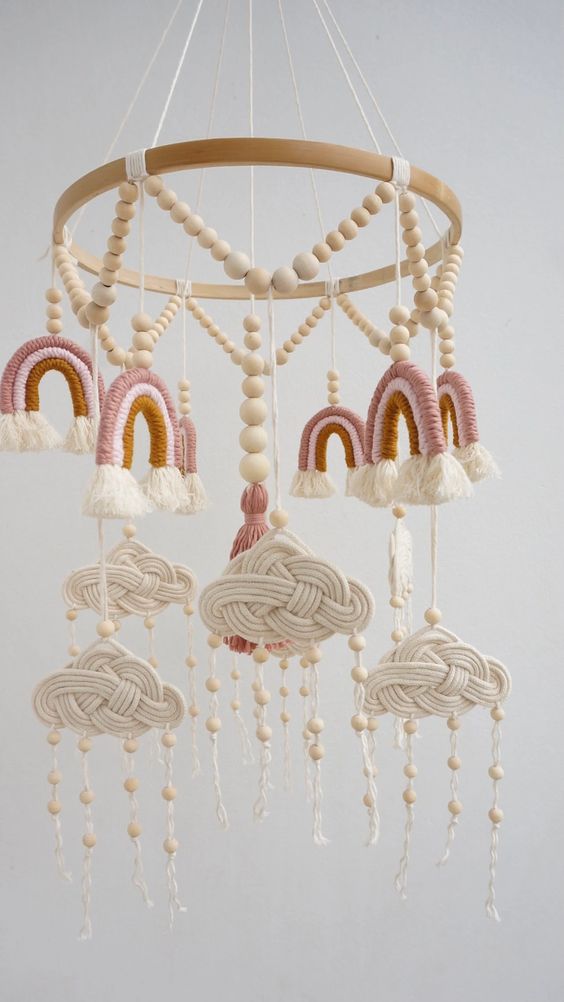 a tiered boho mobile with macrame rainbows and wooden beams, woven clouds and wood bead raindrops is amazing