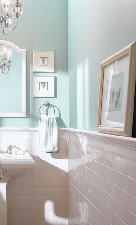use sleek ledges in your bathroom to display art and accessories and make the space look cooler