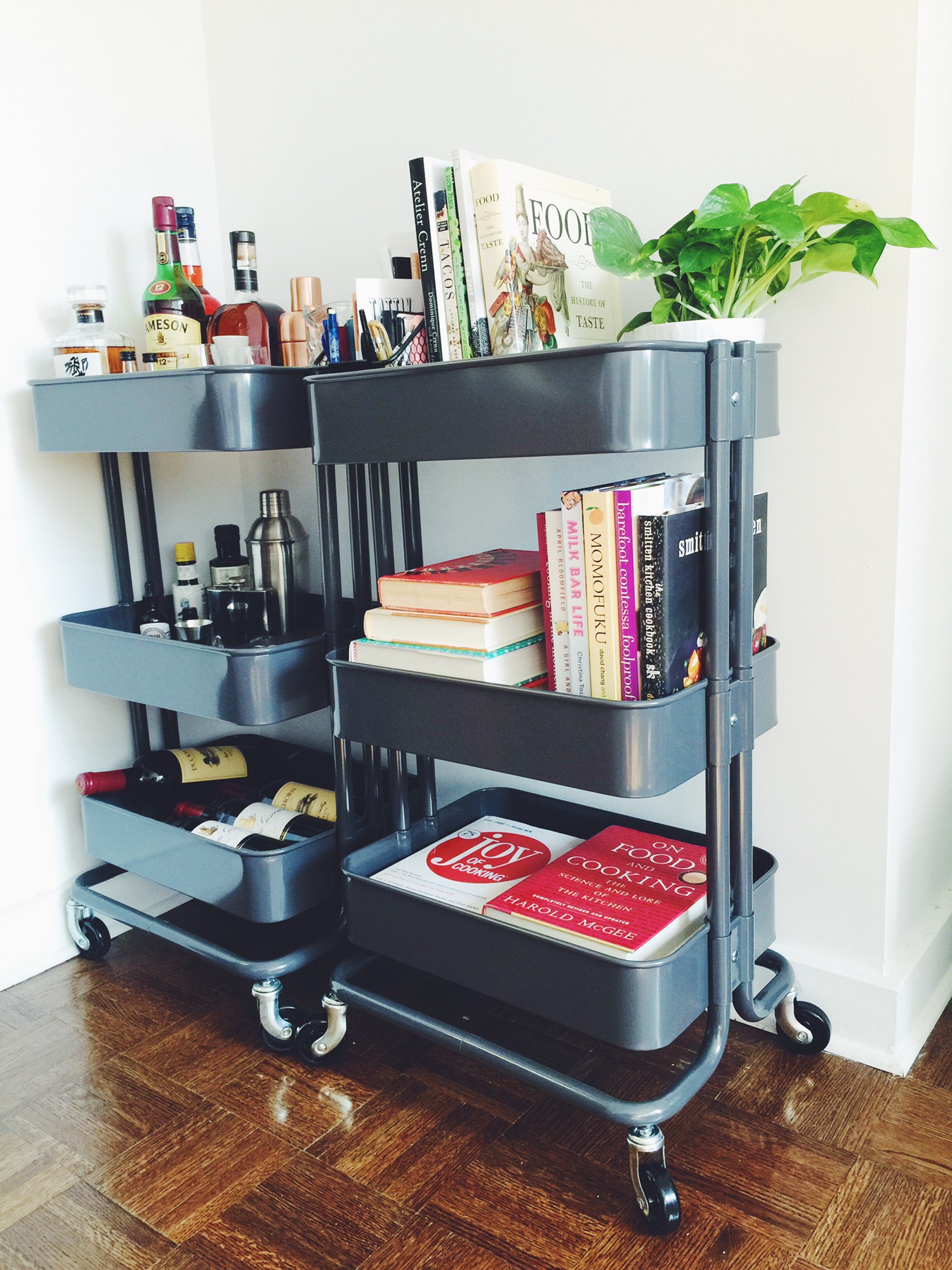 Two black carts here are used as a mixing station and as a storage rack for cooking books.